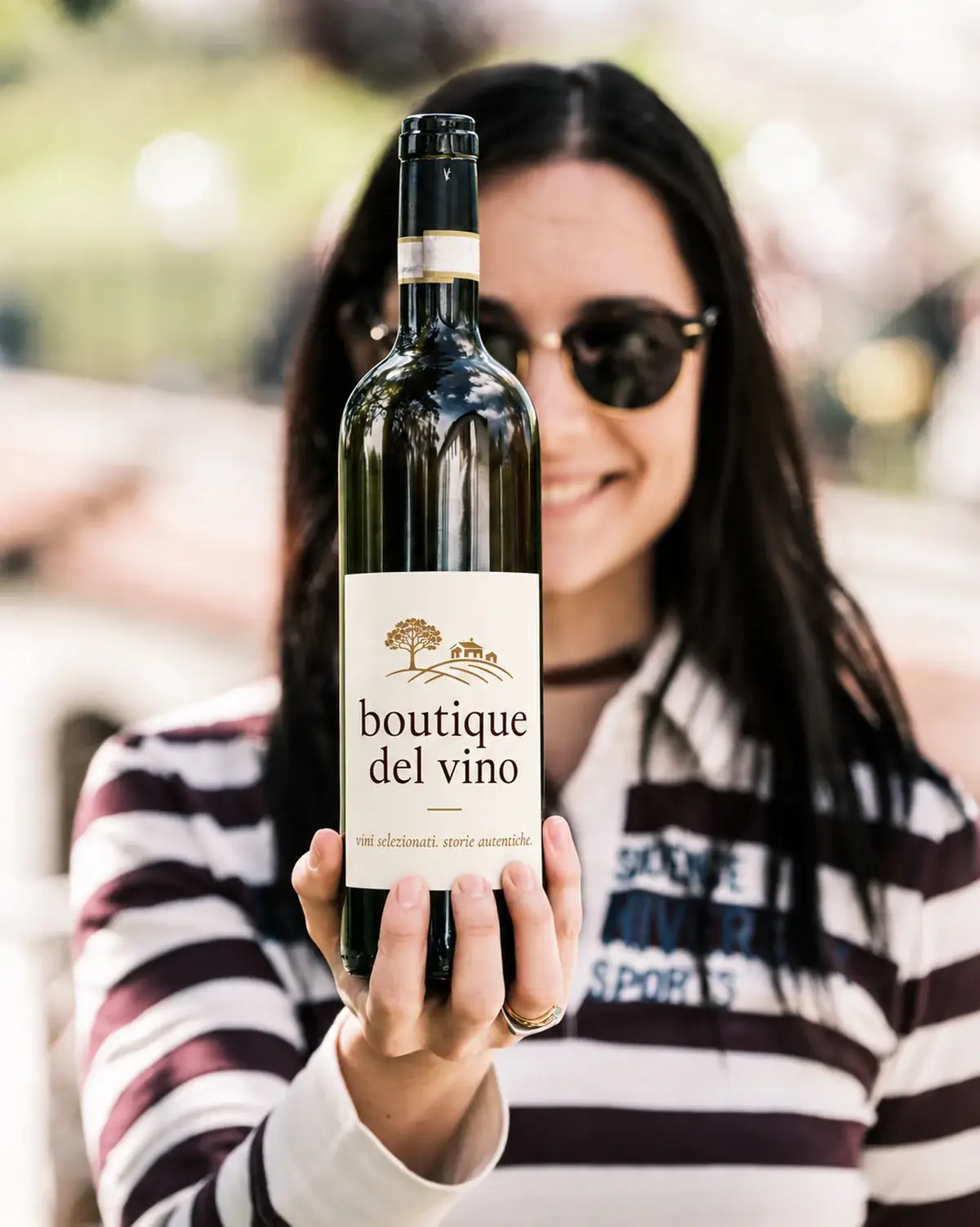 Eine Flasche boutique del vino, in die Sonne gehalten